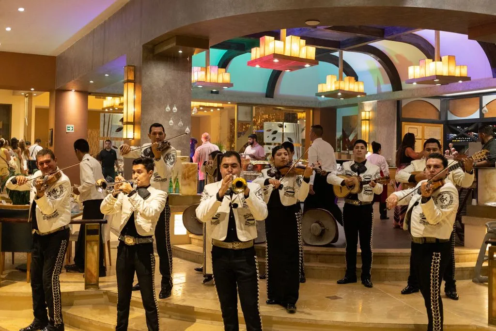 Mariachi band performing in an elegant restaurant during dinner.